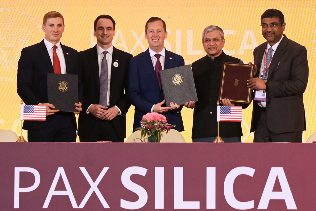 India's IT Minister Ashwini Vaishnaw, second right, poses for a photograph with U.S. Ambassador to India Sergio Gor, center, U.S. Under Secretary of State for Economic Affairs Jacob Helberg, first left, and other officials after signing an agreement in New Delhi, India, Friday, Feb. 20, 2026. (AP Photo)