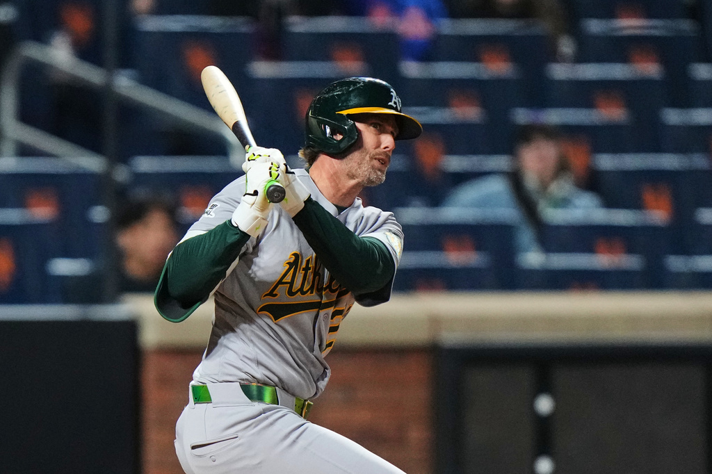 Athletics' Jeff McNeil follows through on a double during the fourth inning of a baseball game against the New York Mets Friday, April 10, 2026, in New York. (AP Photo/Frank Franklin II)