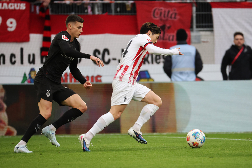 Mönchengladbach's Yannik Engelhardt, left, and Freiburg's Yuito Suzuki in action during the Bundesliga soccer match between SC Freiburg and Borussia Mönchengladbach in Freiburg, Germany, Sunday Feb. 22, 2026. (Philipp von Ditfurth/dpa via AP)