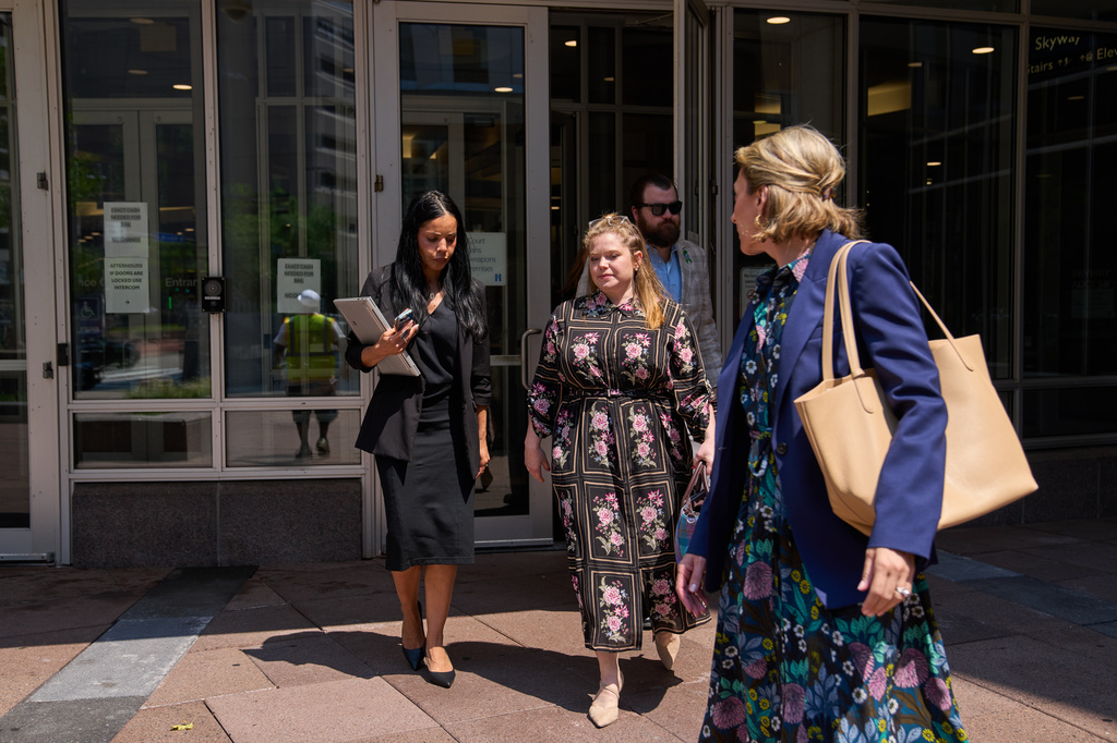 Colin Hortman, behind, son of Melissa and Mark Hortman, and his wife Alina Bachman Hortman, second from left, leave after attending the initial state court appearance for Vance Boelter, Monday, Aug. 3, 2026, in Minneapolis. (AP Photo/Ellen Schmidt)