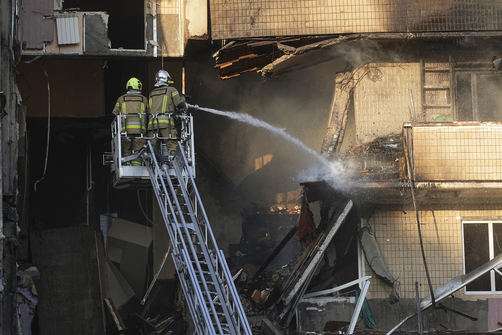 Emergency services personnel work to extinguish a fire after a Russian attack in Kyiv, Ukraine, Sunday, Sept. 7, 2025. (AP Photo/Efrem Lukatsky)