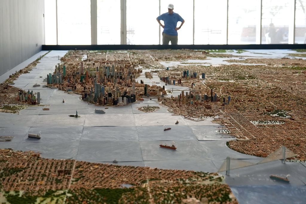 A visitor to the Museum of the City of New York looks over a model of New York City made by Joe Macken in New York, Monday, Sept. 14, 2026. (AP Photo/Seth Wenig)