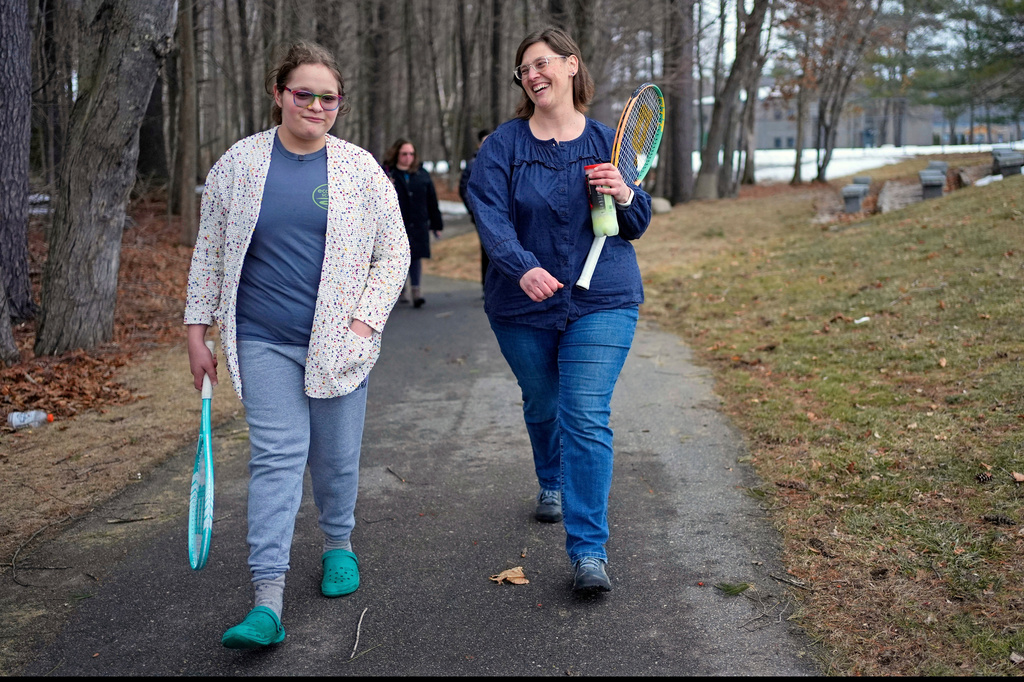 FILE - Iris Turmelle walks with her mom, Amy Manzelli, near her high school's tennis courts, Wednesday, March 5, 2025, in Pembroke, N.H. (AP Photo/Robert F. Bukaty, File)