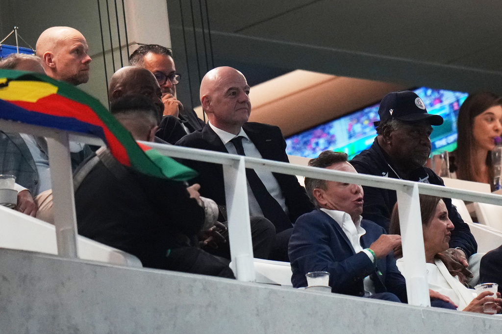 FIFA President Gianni Infantino, center, watches a World Cup playoff semifinal soccer match between New Caledonia and Jamaica in Guadalajara, Mexico, Thursday, March 26, 2026. (AP Photo/Eduardo Verdugo)