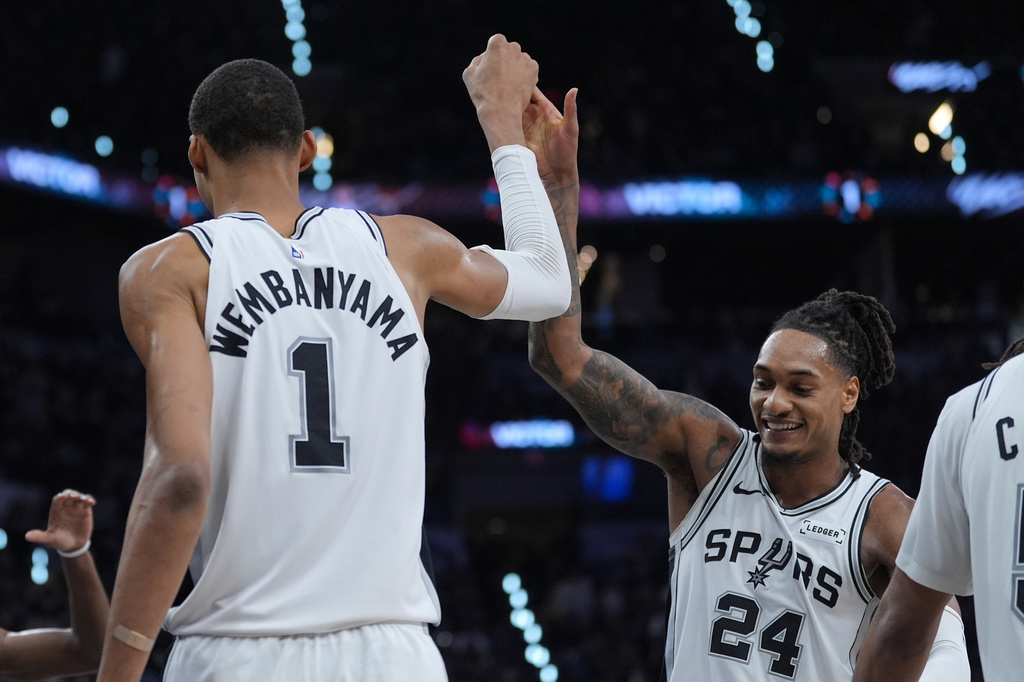San Antonio Spurs forward/center Victor Wembanyama (1) reacts with guard/forward Devin Vassell (24) during the second half in Game 5 of a first-round NBA playoffs basketball series against the Portland Trail Blazers, in San Antonio, Tuesday, April 28, 2026. (AP Photo/Eric Gay)