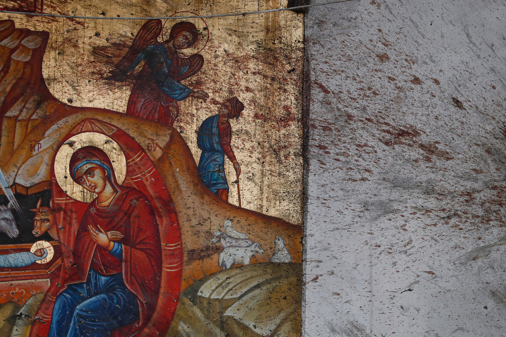 Blood stains a religious icon of the Virgin Mary and child inside the Mar Elias Greek Orthodox Church, during a memorial service, a day after a suicide bombing, in Dweil'a on the outskirts of Damascus, Syria, June 23, 2025. (AP Photo/Omar Sanadiki, File)