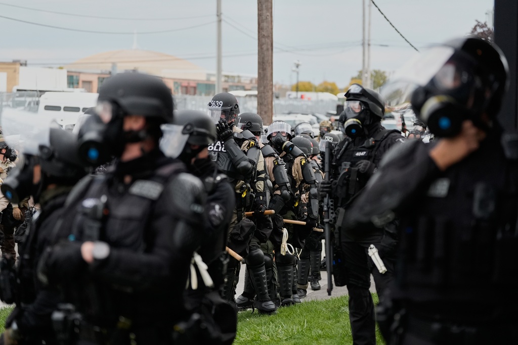 Law enforcement officers line up as protesters gather outside an ICE processing facility in the Chicago suburb of Broadview, Ill., Saturday, Nov. 1, 2025. (AP Photo/Alex Brandon)