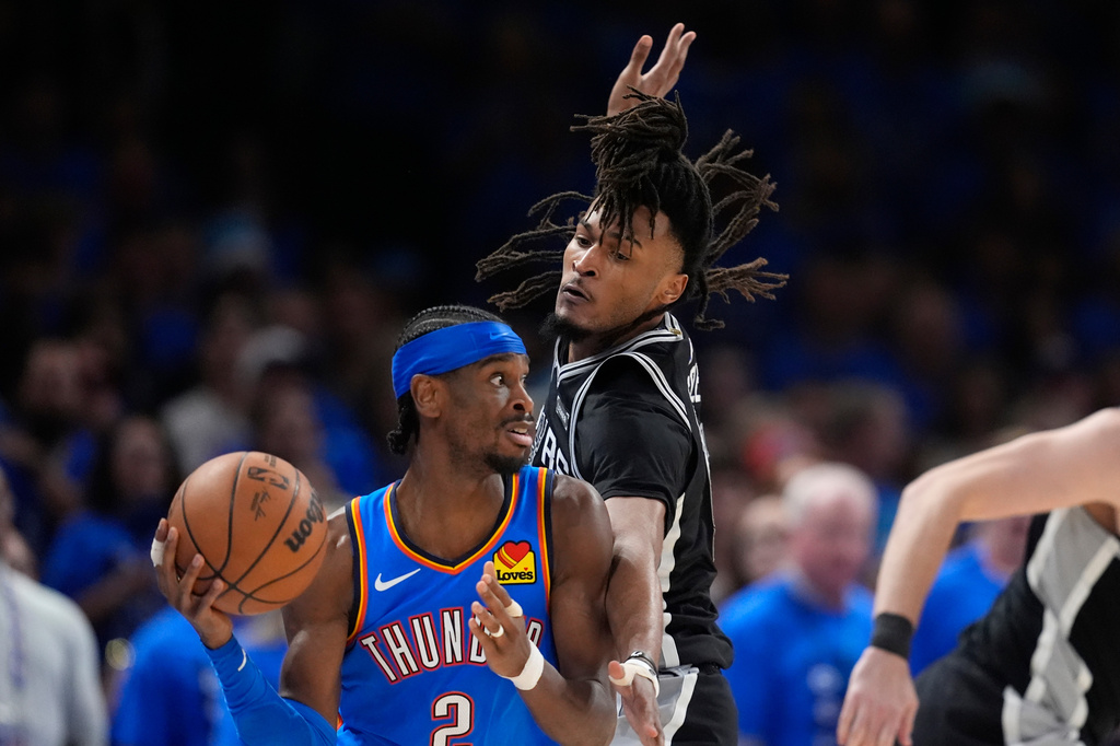 Oklahoma City Thunder guard Shai Gilgeous-Alexander (2) looks to pass the ball as San Antonio Spurs guard Stephon Castle defends during the second half of Game 7 of the Western Conference finals of the NBA basketball playoffs series Saturday, May 30, 2026, in Oklahoma City. (AP Photo/Tony Gutierrez)