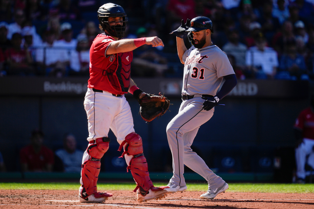 Detroit Tigers' Riley Greene scores behind Cleveland Guardians catcher Austin Hedges on a sacrifice bunt hit by Zach McKinstry in seventh inning of Game 1 of the American League Wild Card baseball playoff series in Cleveland, Tuesday, Sept. 30, 2025. (AP Photo/Sue Ogrocki)