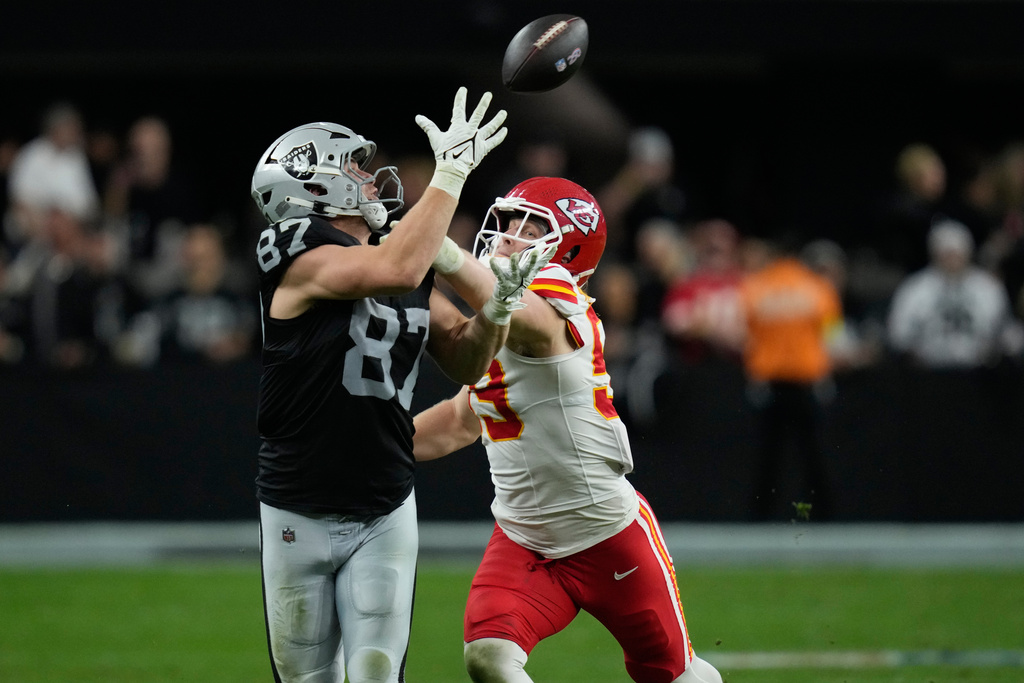Las Vegas Raiders tight end Michael Mayer (87) catches a pass as Kansas City Chiefs linebacker Cooper McDonald defends during the second half of an NFL football game Sunday, Jan. 4, 2026, in Las Vegas. (AP Photo/John Locher)