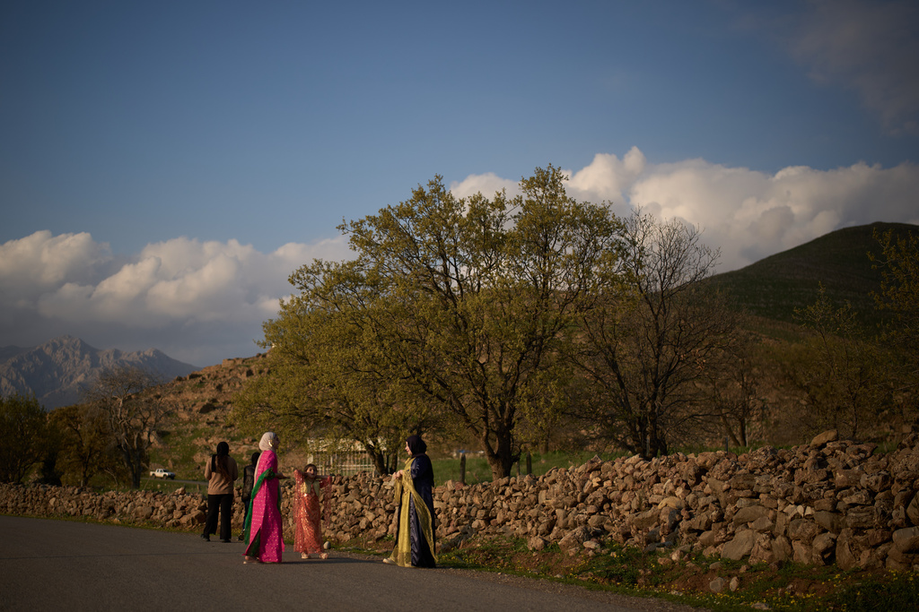 Wearing traditional clothes young women take part in a family gathering at the village of Gulp, Iraq, Tuesday, March 17, 2026. (AP Photo/Leo Correa)