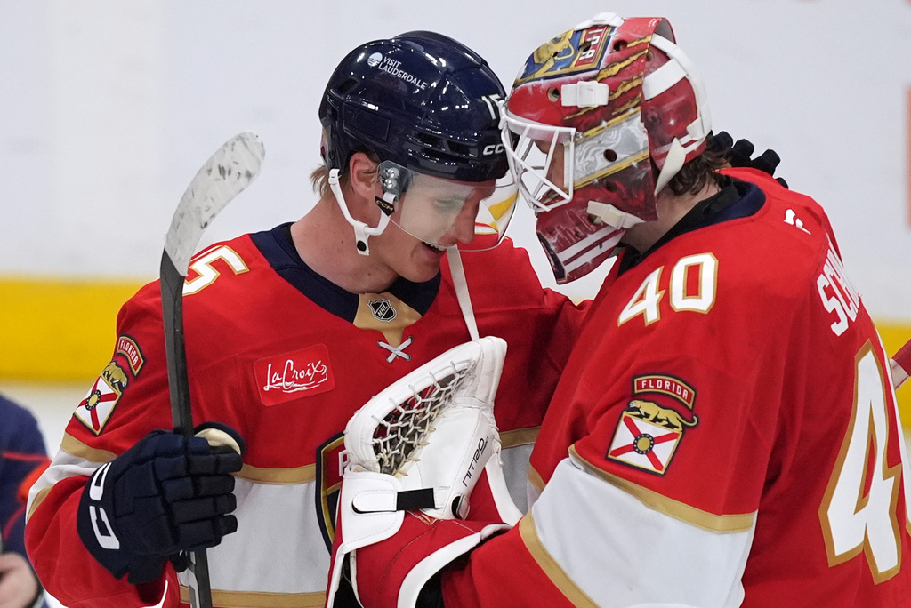 Florida Panthers center Anton Lundell (15) celebrates with goaltender Akira Schmid (40) at the end of an NHL hockey game in which he scored a hat trick against the Winnipeg Jets, Friday, Oct. 30, 2026, in Sunrise, Fla. (AP Photo/Rebecca Blackwell)