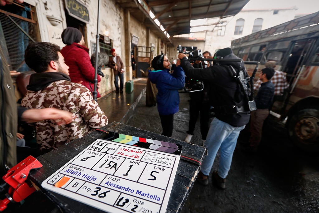 A television crew films an episode of the TV series "Al-Souriyoun al-Aada" ("The Syrian Enemies"), based on a novel of the same name that was banned under Bashar Assad, along a transformed street in central Aleppo, Syria, Friday, Feb. 13, 2026.(AP Photo/Omar Sanadiki)