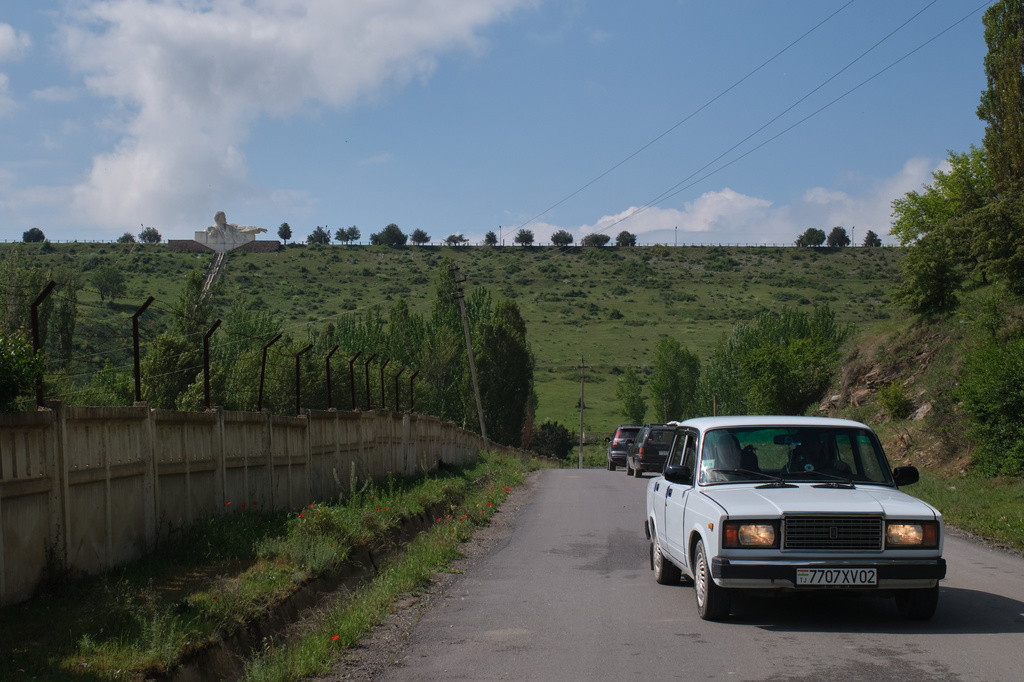 A Lada drives away from the world's largest bust of Vladimir Lenin, in Istaravshan, Tajikistan, Monday, May 4, 2026. (AP Photo/Jon Orbach)