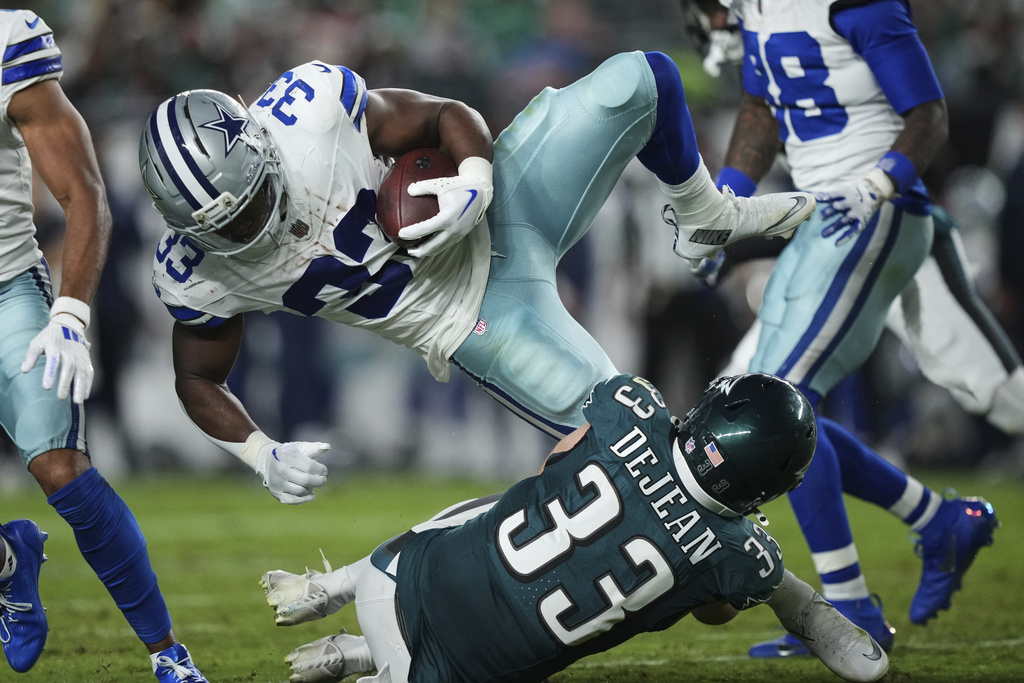 Dallas Cowboys running back Javonte Williams (33) is upended by Philadelphia Eagles cornerback Cooper DeJean (33) as Williams runs the ball in the second half of an NFL football game Thursday, Sept. 4, 2025, in Philadelphia. (AP Photo/Matt Slocum)