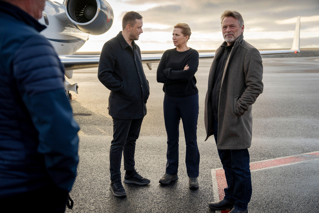 Chairman of the Naalakkersuisut Jens-Frederik Nielsen, centre left, welcomes Danish Prime Minister Mette Frederiksen, centre right, and her husband, Bo Tengberg, right, as they land at Nuuk airport in Greenland, on Tuesday, Sept. 23, 2025. (Mads Claus Rasmussen/Ritzau Scanpix via AP)