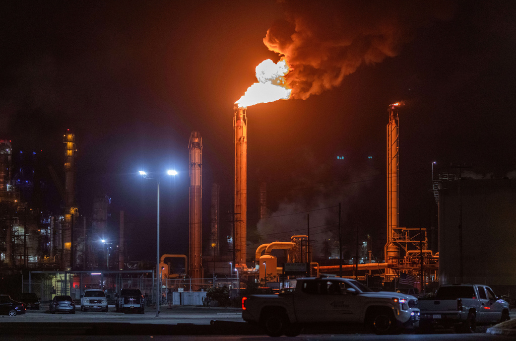 Flames rise from the Chevron refinery in El Segundo, Calif., Thursday, Oct. 2, 2025. (AP Photo/Ethan Swope)