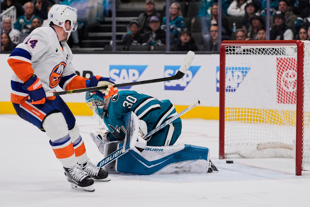 San Jose Sharks goaltender Yaroslav Askarov (30) is unable to stop a goal by New York Islanders center Bo Horvat (14) during overtime of an NHL hockey game, Saturday, March 7, 2026, in San Jose, Calif. (AP Photo/Godofredo A. Vásquez)