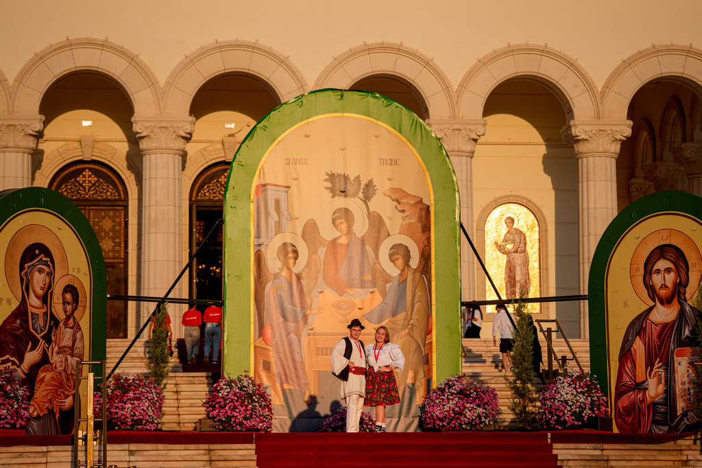 Youngsters wearing traditional outfits pose backdropped by religious icons before the Procession of Lights, part of a four-day program of the International Meeting of Orthodox Youth (ITO), in Bucharest, Romania, Wednesday, Sept. 2, 2026. (AP Photo/Andreea Alexandru)