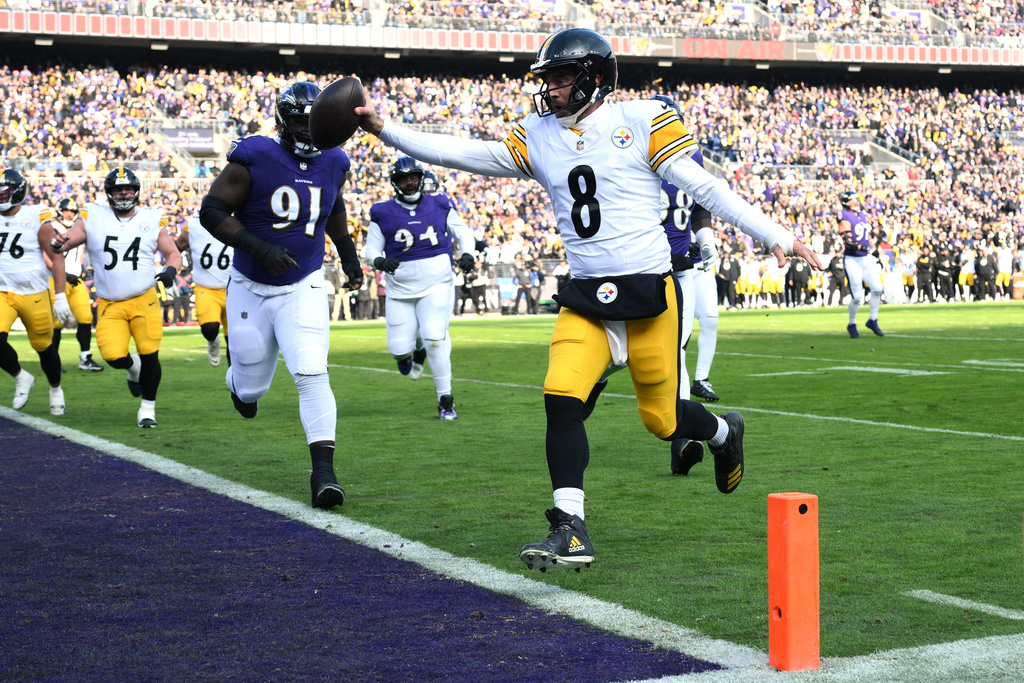 Pittsburgh Steelers quarterback Aaron Rodgers (8) runs to the end zone for a touchdown during the first half of an NFL football game against the Baltimore Ravens, Sunday, Dec. 7, 2025, in Baltimore. (AP Photo/Nick Wass)