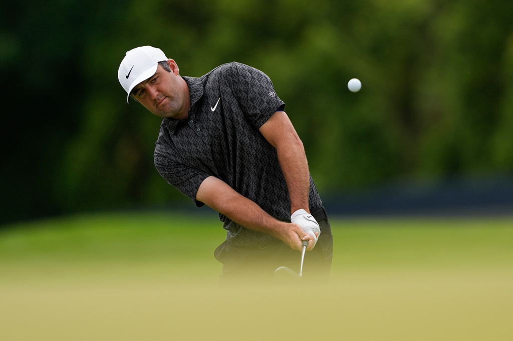 Scottie Scheffler chips onto the 13th green during a PGA Championship golf tournament practice round at Aronimink Golf Club, Wednesday, May 13, 2026, in Newtown Square, PA. (AP Photo/Carolyn Kaster)