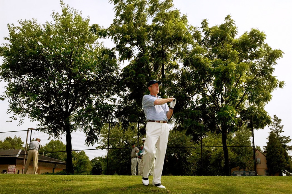 FILE - President George W. Bush practices his swing as he prepares to tee off on the first hole at the golf course at Andrews Air Force Base, Md., July 3, 2002. (AP Photo/Pablo Martinez Monsivais, File)