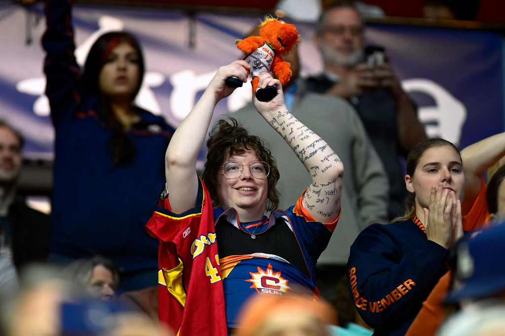 Fan Cass Meehan waves the Connecticut Sun mascot in the air during the first half of a WNBA basketball game between the Sun and the Toronto Tempo, Thursday, Sept. 24, 2026, in Uncasville, Conn. (AP Photo/Jessica Hill)