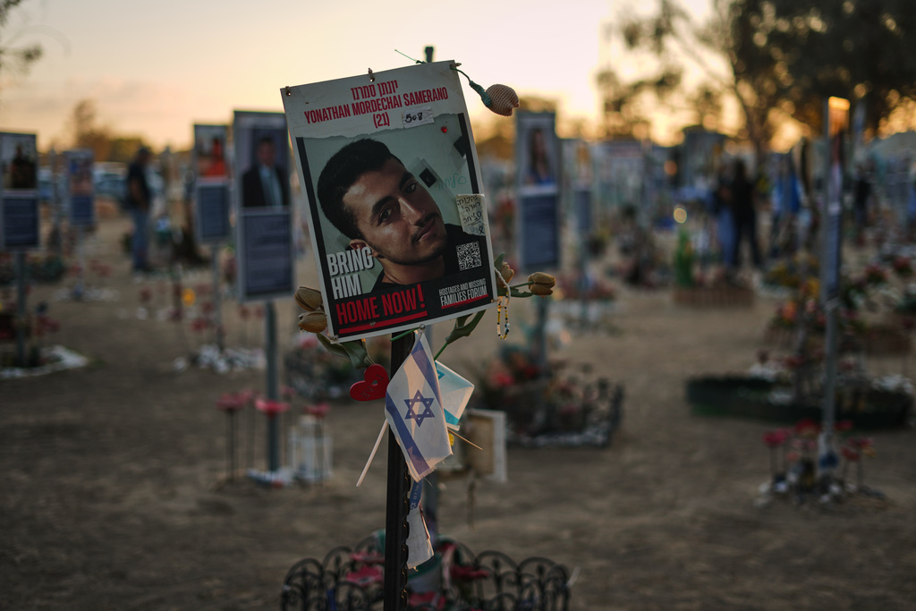 A photo of Yonathan Samerano, who was killed in the Hamas cross-border attack on Israel on Oct. 7, 2023, is seen in the site of the Nova music festival, where hundreds of revelers were killed and abducted by Hamas, as Israel marks the second year anniversary of the attack, near Kibbutz Reim, southern Israel, Tuesday, Oct. 7, 2025. (AP Photo/Ariel Schalit)