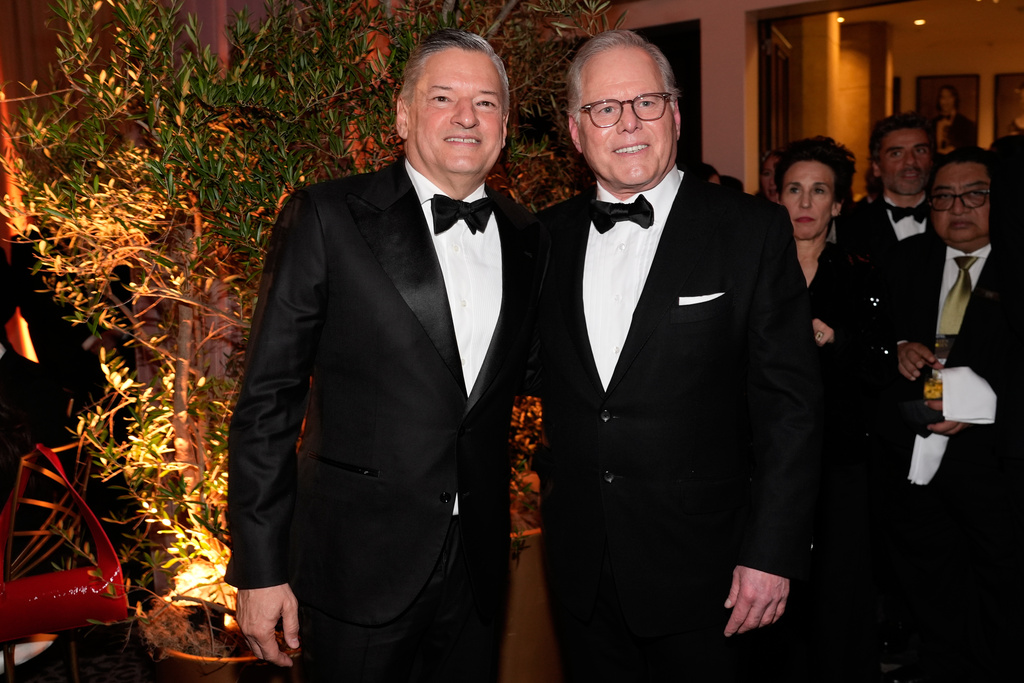 Ted Sarandos, CEO of Netflix, left, and David Zaslav, CEO and President of Warner Bros. Discovery, arrives at the 83rd Golden Globes on Sunday, Jan. 11, 2026, at the Beverly Hilton in Beverly Hills, Calif. (AP Photo/Chris Pizzello)