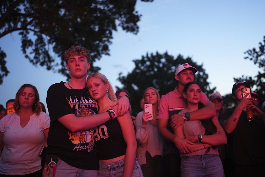 Utah Valley University students Zach Zimmerman, second from left, and Lauren Simons embrace during a vigil for Charlie Kirk, the CEO and co-founder of Turning Point USA who was shot and killed, Thursday, Sept. 11, 2025, in Orem, Utah. Zimmerman witnessed the shooting. (AP Photo/Lindsey Wasson)