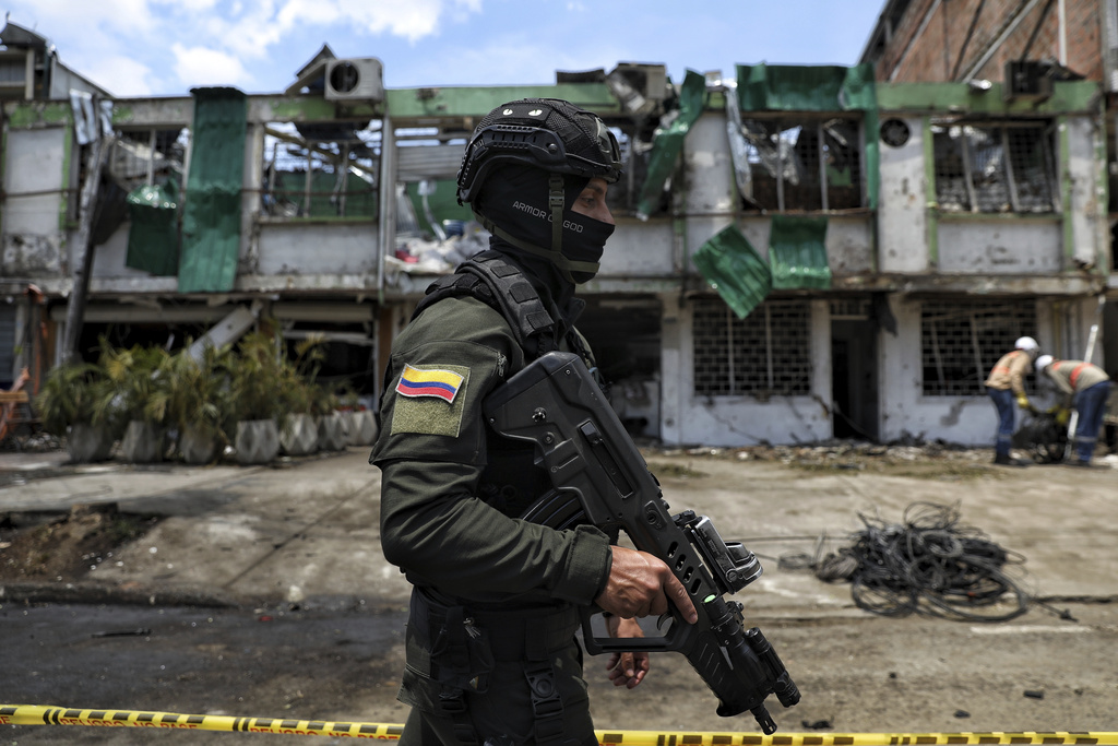 Police guard the area damaged a day earlier by a car bomb explosion outside an Air Force base in Cali, Colombia, Friday, Aug. 22, 2025. (AP Photo/Santiago Saldarriaga)