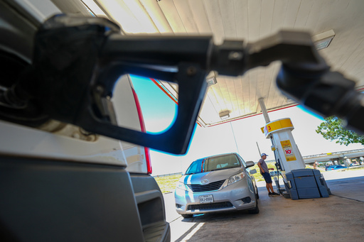 FILE - A person pays for fuel at a Shell gas station, Tuesday, July 29, 2025, in Arlington, Texas. (AP Photo/Julio Cortez, File) FILE - A person pays for fuel at a Shell gas station, Tuesday, July 29, 2025, in Arlington, Texas. (AP Photo/Julio Cortez, File)