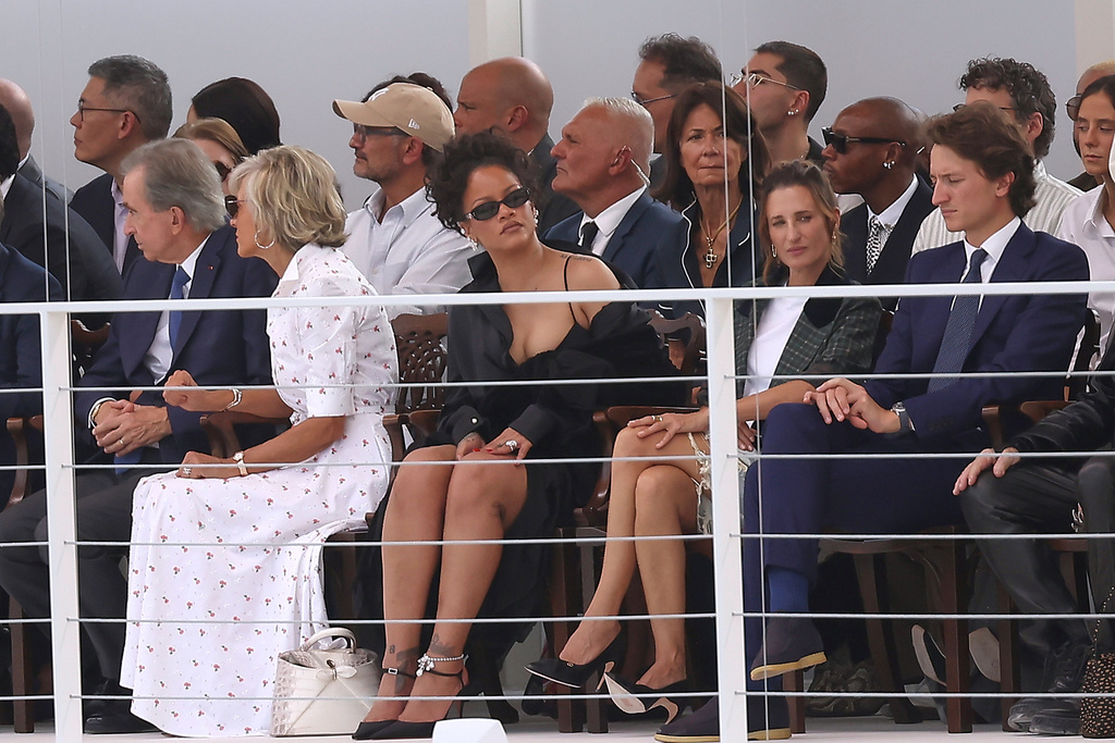 Rihanna, centre, and Camille Cottin, centre right, watch the Christian Dior Womenswear Spring Summer 2027 collection presented in Paris, France, Tuesday, Sept. 29, 2026. (AP Photo/Thomas Padilla)