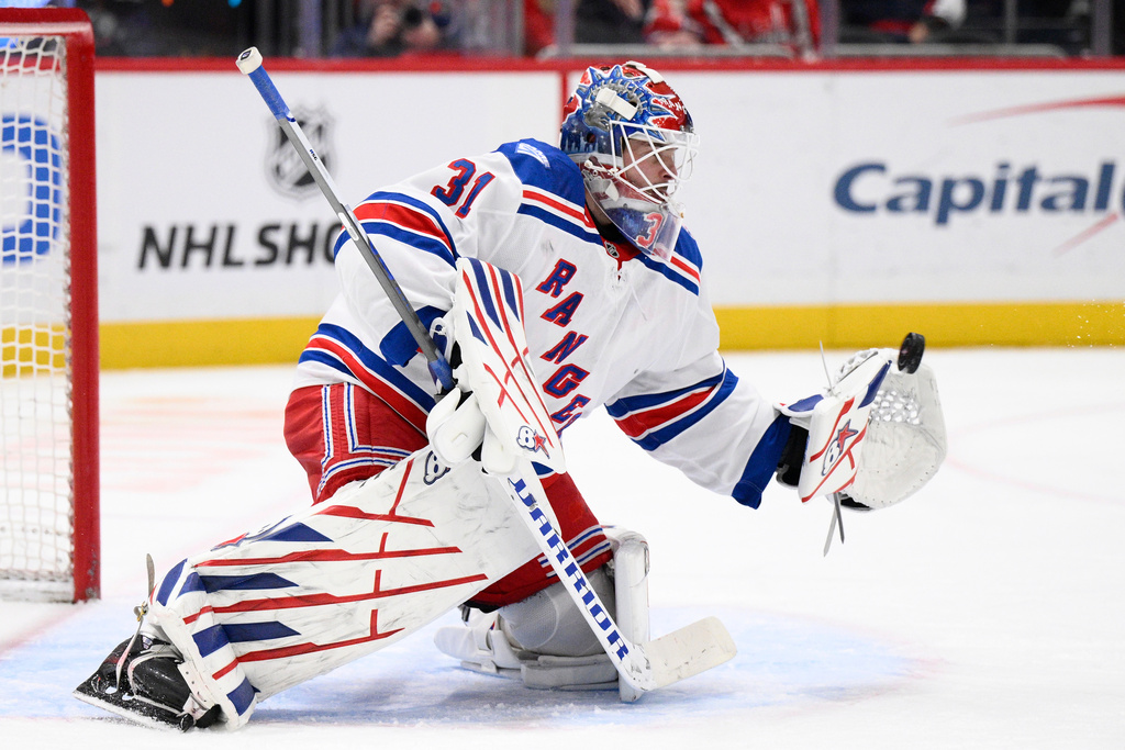 New York Rangers goaltender Igor Shesterkin (31) stops the puck during the first period of an NHL hockey game against the Washington Capitals, Tuesday, Dec. 23, 2025, in Washington. (AP Photo/Nick Wass)