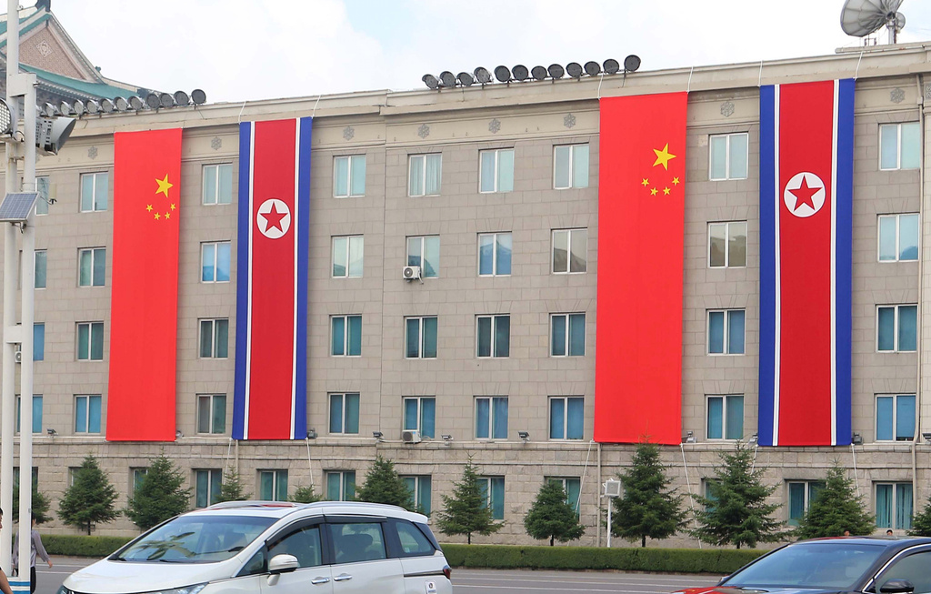A building is decorated with the flags of China and North Korea in Pyongyang, Monday, June 8, 2026. (AP Photo/Jon Chol Jin)