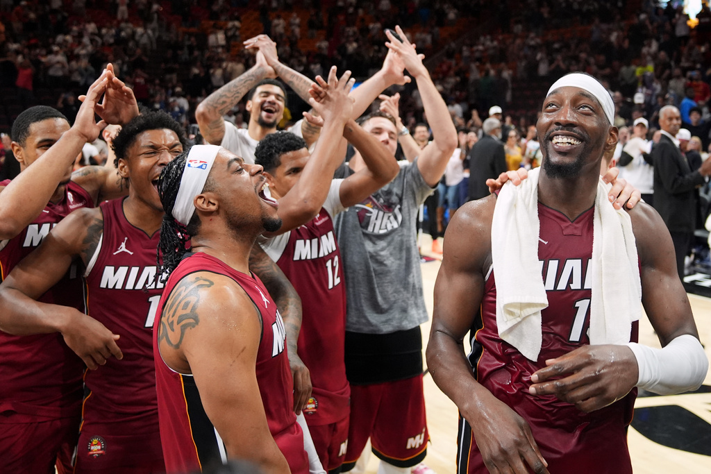 Miami Heat center Bam Adebayo, right, celebrates with teammates after he scored 83 points, the second-highest single game total in NBA history, in an NBA basketball game against the Washington Wizards, Tuesday, March 10, 2026, in Miami. (AP Photo/Rebecca Blackwell)