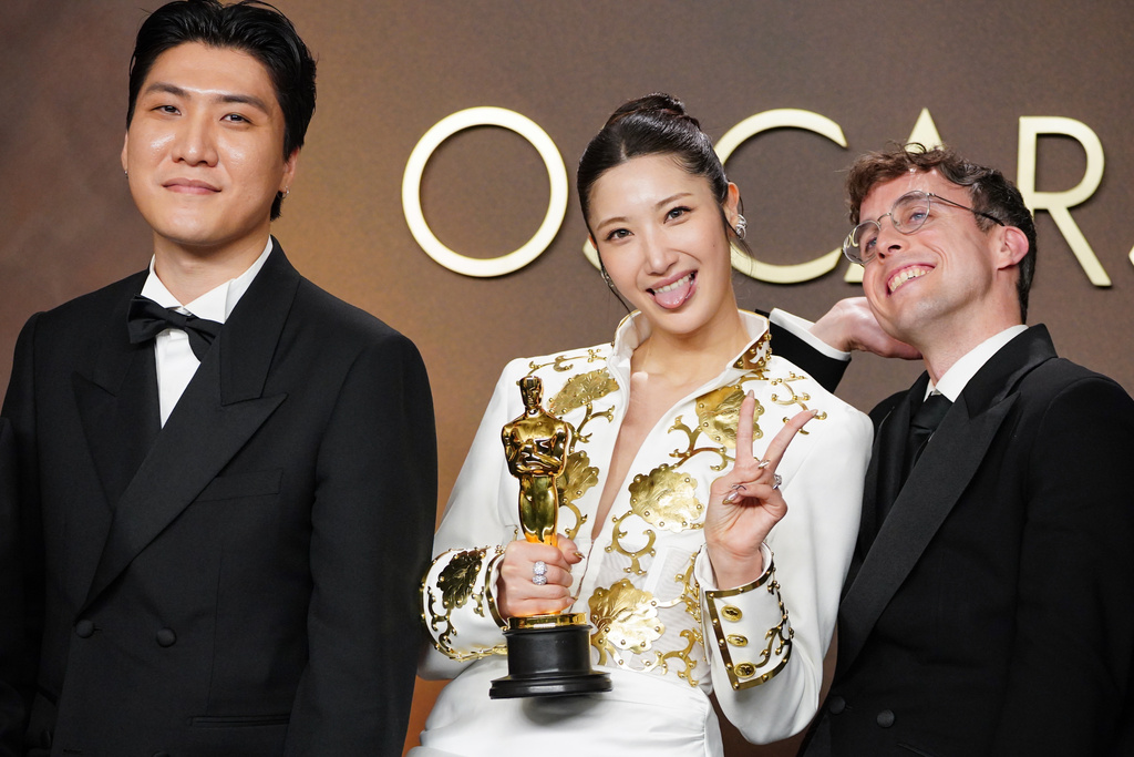 Joong Gyu Kwak, from left, EJAE, and Mark Sonnenblick, winners of the award for music (original song) for "Golden" from "K-pop Demon Hunters," pose in the press room at the Oscars on Sunday, March 15, 2026, at the Dolby Theatre in Los Angeles. (Photo by Jordan Strauss/Invision/AP)