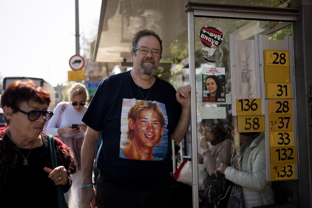 FILE - Yossi Tzur stands at the bus stop near where his 17-year-old son, Assaf, was killed in a bus bombing in 2003 that killed 17 people in Haifa, Israel, Feb. 18, 2025. (AP Photo/Maya Alleruzzo, File)