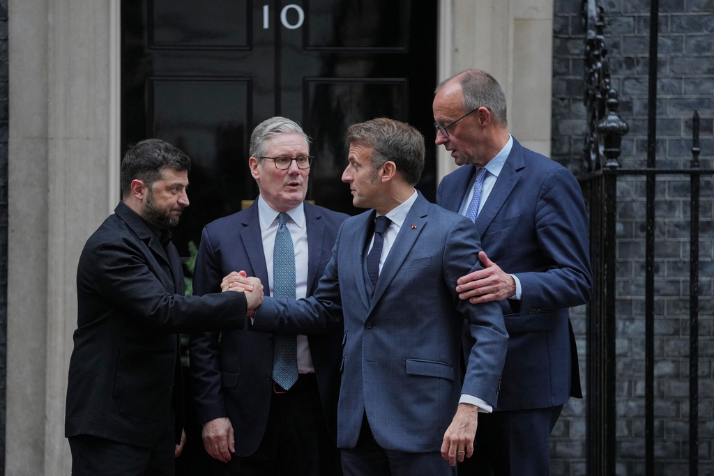 Ukrainian President Volodymyr Zelenskyy, left, with Britain's Prime Minister Keir Starmer, French President Emmanuel Macron, and German Chancellor Friedrich Merz pose on the doorstep of 10 Downing Street, London, Monday, Dec. 8, 2025, following a meeting of the leaders inside. (AP Photo/Kin Cheung)