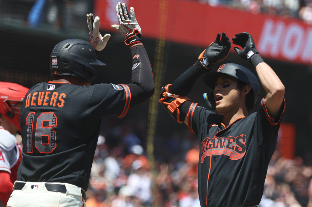 San Francisco Giants' Jung Hoo Lee, right, celebrates with Rafael Devers (16) after hitting a three-run home run against the Los Angeles Angels during the third inning of a baseball game in San Francisco, Saturday, July 25, 2026. (AP Photo/Jed Jacobsohn)
