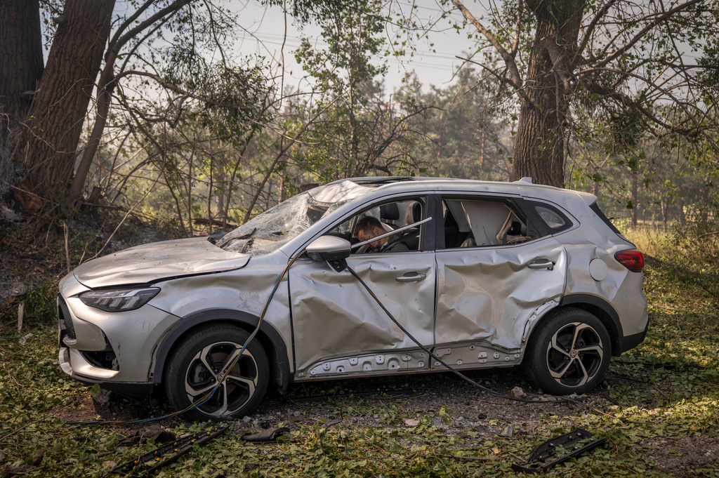 The body of driver, after a Russian attack struck a warehouse, followed by an explosion, in the village of Myla, Kyiv region, Ukraine, Saturday, Aug. 29, 2026. (AP Photo/Dan Bashakov)