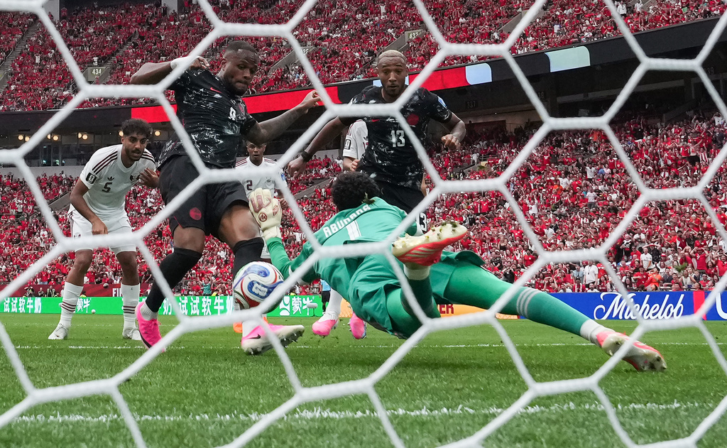 Canada's Cyle Larin (9) scores against Qatar goalkeeper Mahmoud Abunada (1) during the World Cup Group B soccer match between Canada and Qatar in Vancouver, British Columbia, Thursday, June 18, 2026. (Darryl Dyck/The Canadian Press via AP)