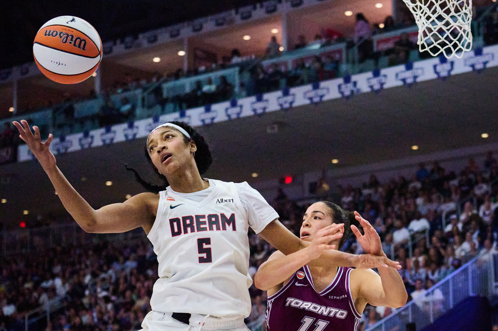 Atlanta Dream's Angel Reese (5) wins a rebound against Toronto Tempo's Kia Nurse, right, during the first half of a WNBA basketball game in Toronto, Friday, July 17, 2026. (Sammy Kogan/The Canadian Press via AP)
