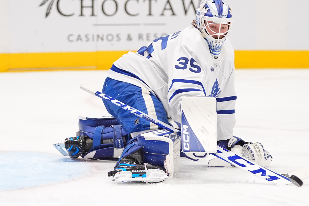 Toronto Maple Leafs goaltender Dennis Hildeby deflects the puck during the first period of an NHL hockey game against the Dallas Stars, Sunday, Dec. 21, 2025, in Dallas. (AP Photo/LM Otero)