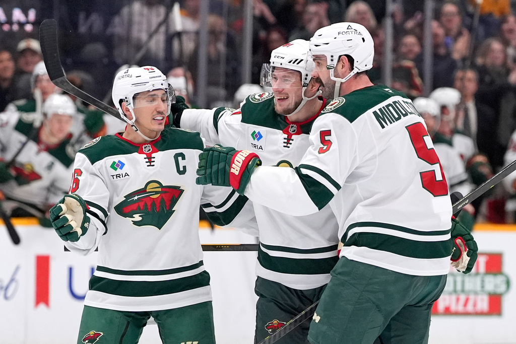 Minnesota Wild right wing Vladimir Tarasenko, center, celebrate his goal with defensemen Jared Spurgeon (46) and Jake Middleton (5) during the third period of an NHL hockey game against the Nashville Predators, Wednesday, Feb. 4, 2026, in Nashville, Tenn. (AP Photo/George Walker IV)