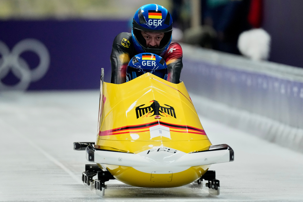 Germany's Johannes Lochner, right, and Georg Fleischhauer start for a two man bobsled run at the 2026 Winter Olympics, in Cortina d'Ampezzo, Italy, Monday, Feb. 16, 2026. (AP Photo/Alessandra Tarantino)