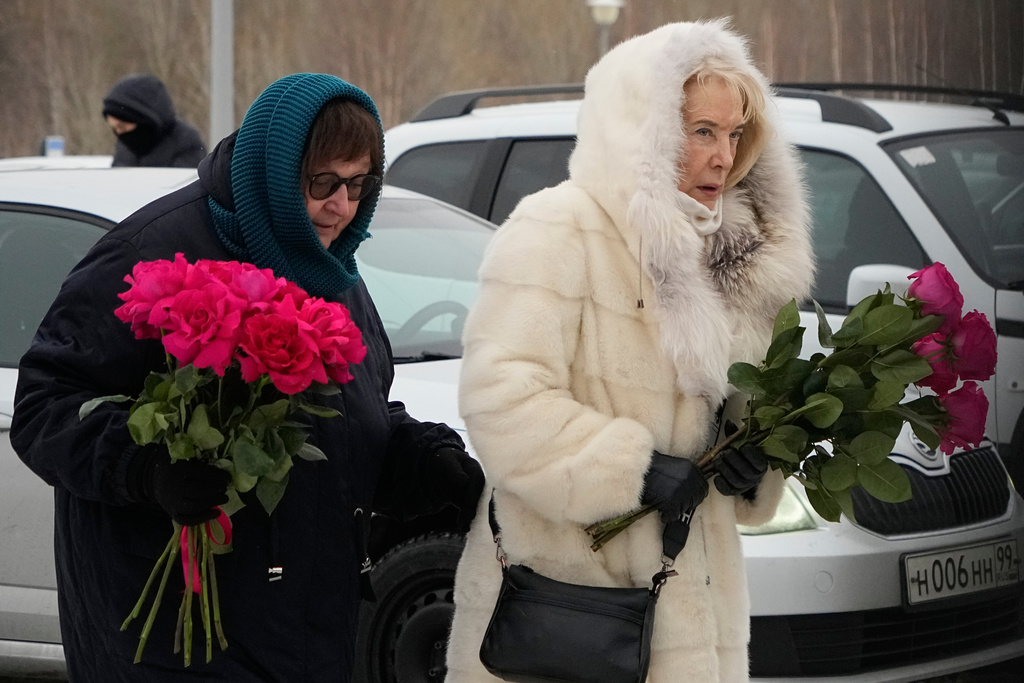 Late Russian opposition leader Alexei Navalny's mother Lyudmila Navalnaya, left, and his mother-in-law Alla Abrosimova, walk to lay flowers at his grave, two years after his death, at the Borisovskoye Cemetery in Moscow, on Monday, Feb. 16, 2026. (AP Photo/Alexander Zemlianichenko)