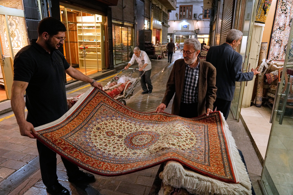 People view rugs at the Grand Bazaar in Tehran, Sunday, May 3, 2026. (AP Photo/Vahid Salemi)