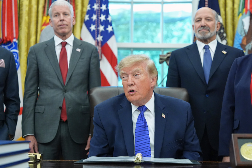 President Donald Trump speaks as Commerce Secretary Howard Lutnick, right, and Energy Secretary Chris Wright listen in the Oval Office of the White House, Monday, Sept. 28, 2026, in Washington. (AP Photo/Alex Brandon)