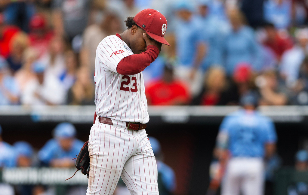 Oklahoma pitcher Xander Mercurius walks back to the dugout after striking out two North Carolina batters with the bases loaded to end the third inning of Game 2 of the NCAA College World Series baseball finals in Omaha, Neb., Sunday, June 21, 2026. (AP Photo/Rebecca S. Gratz)